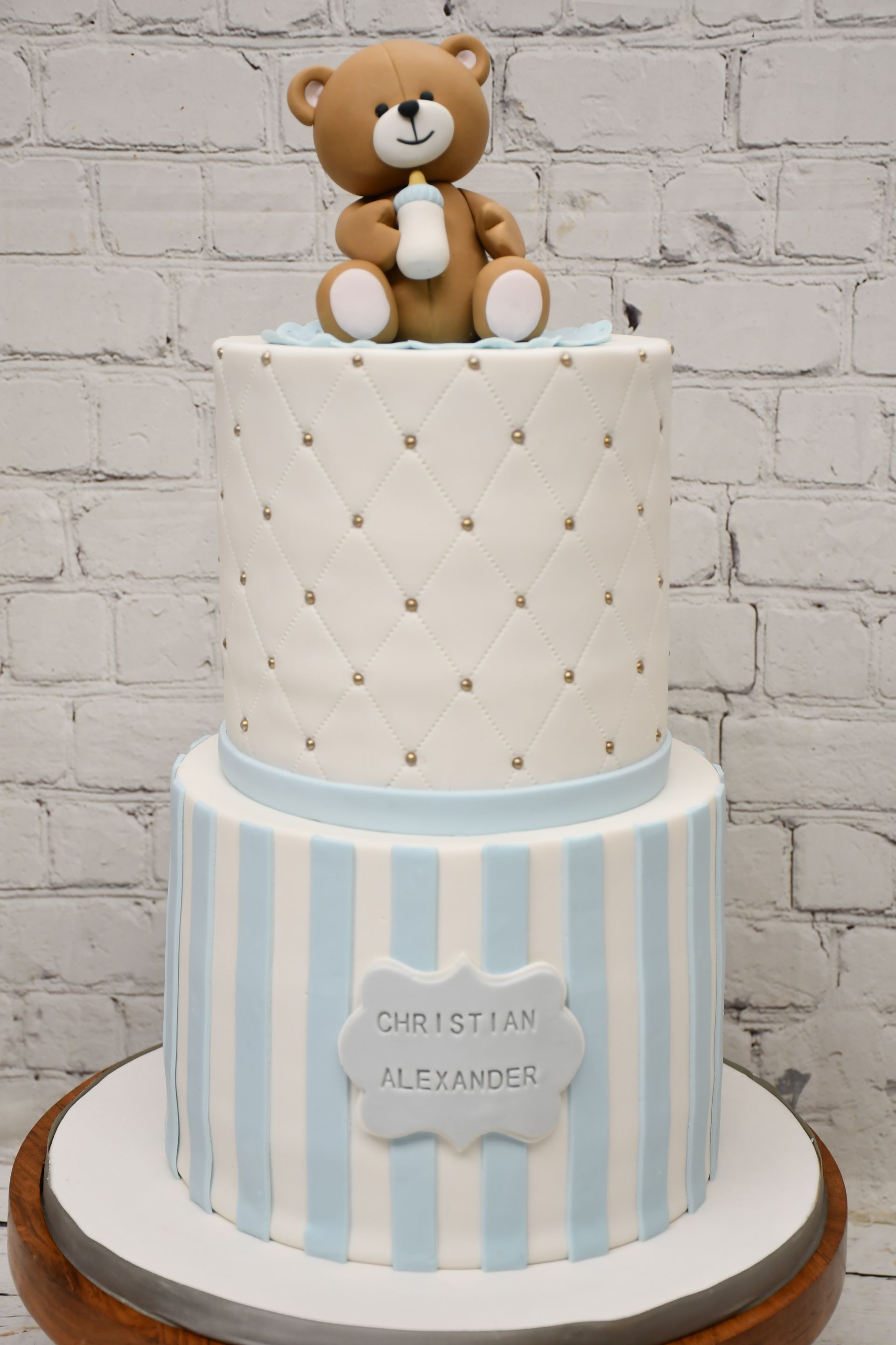 A cake with a teddy bear on top of it