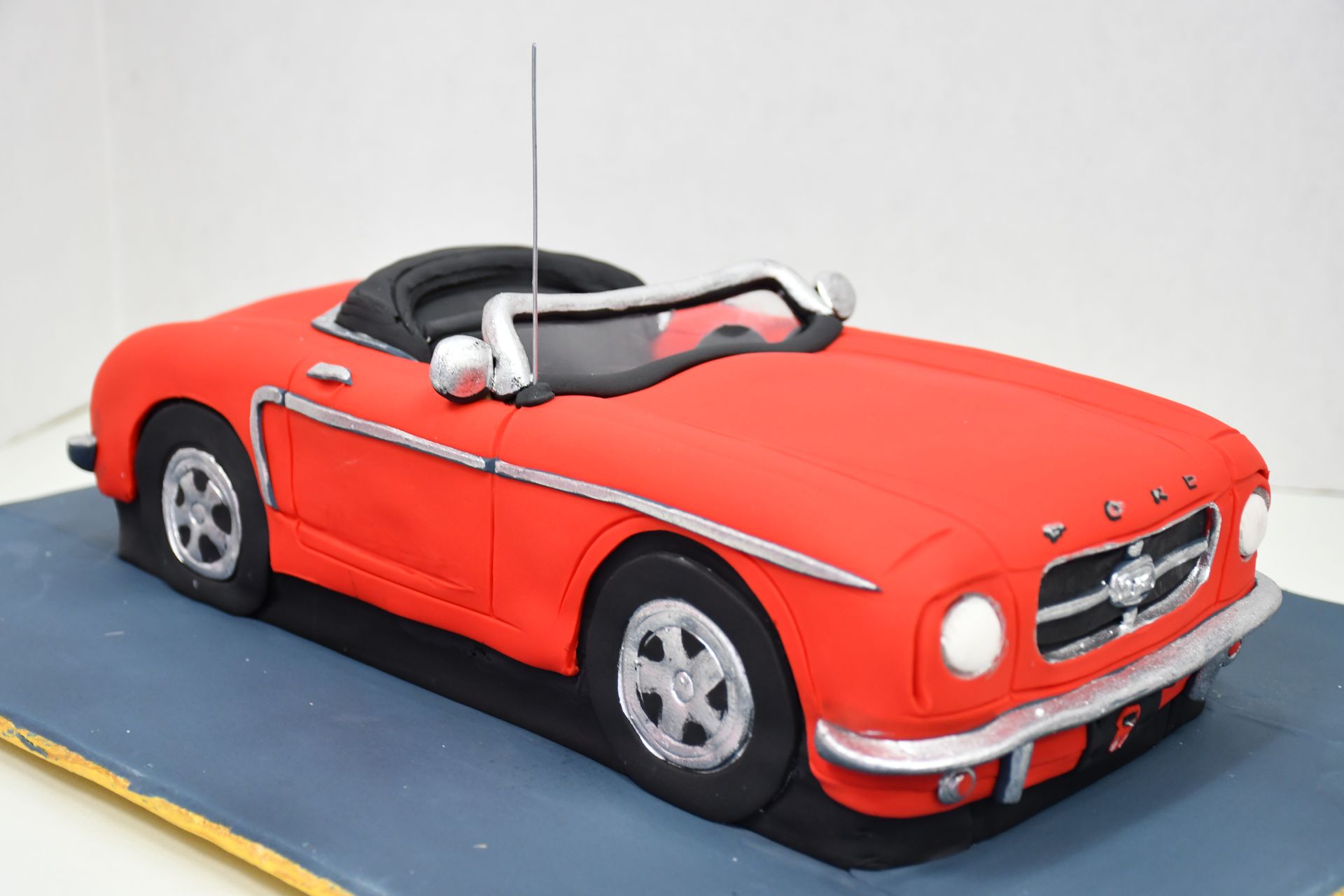 A cake in the shape of a red car