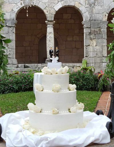 A wedding cake with a bride and groom figurine on top of it