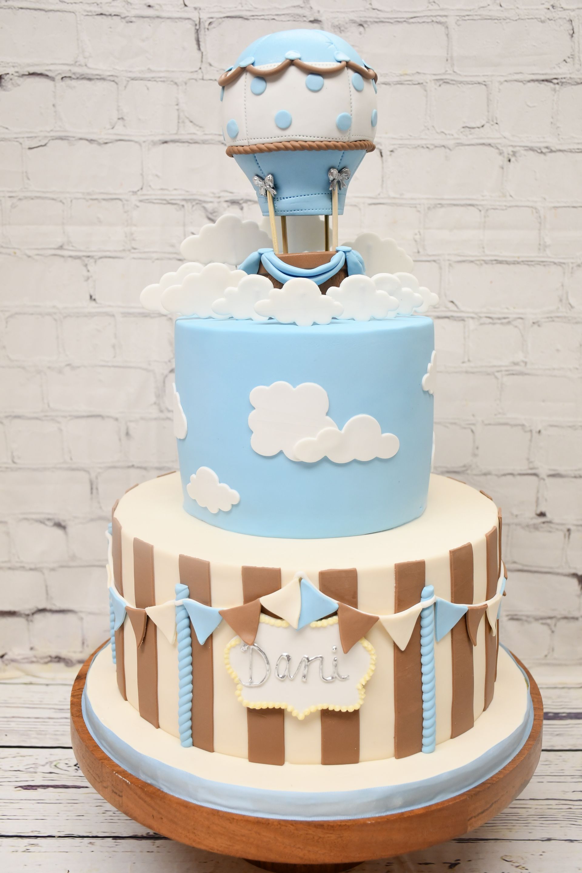 A cake with a hot air balloon on top of it