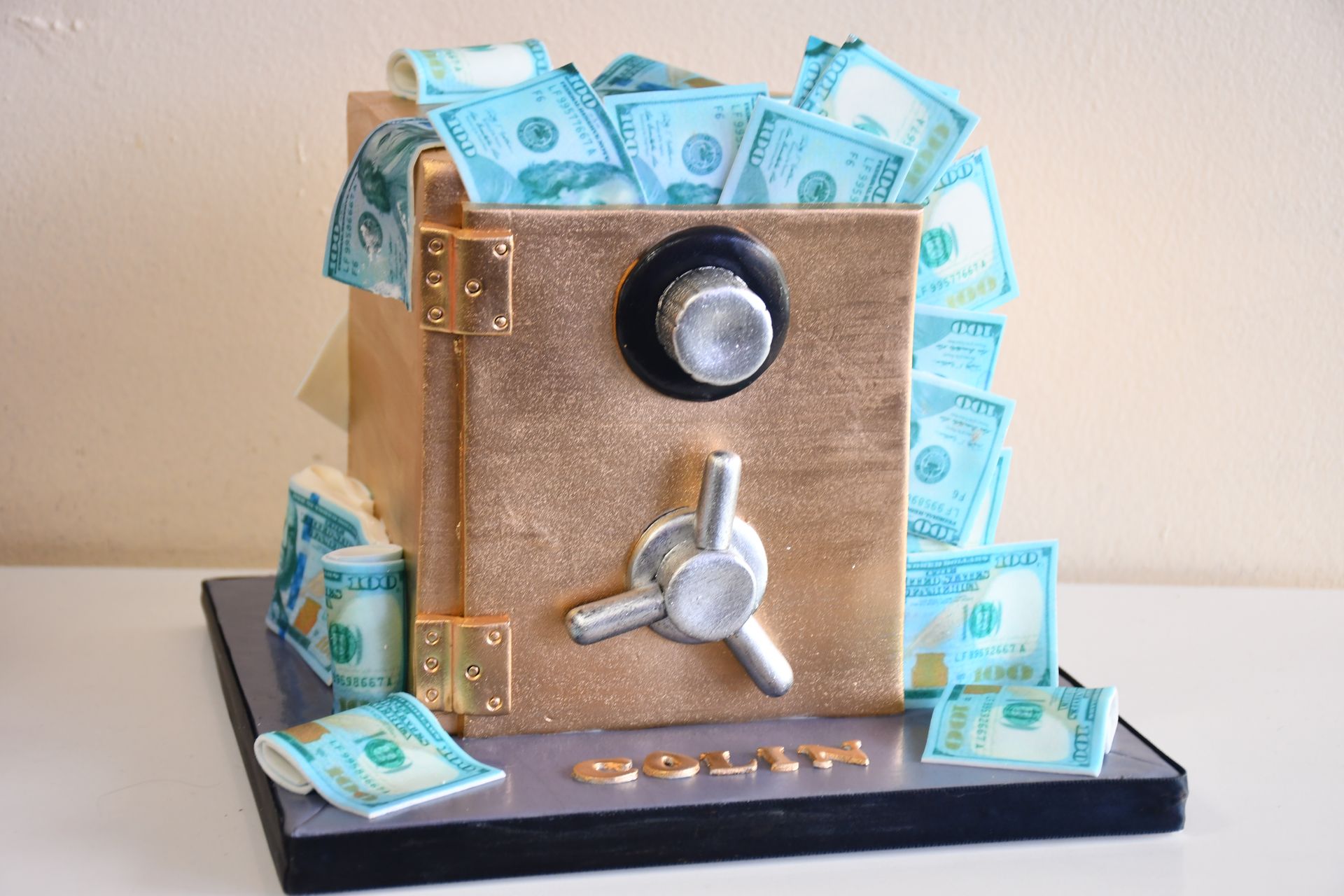 A cake in the shape of a safe filled with money