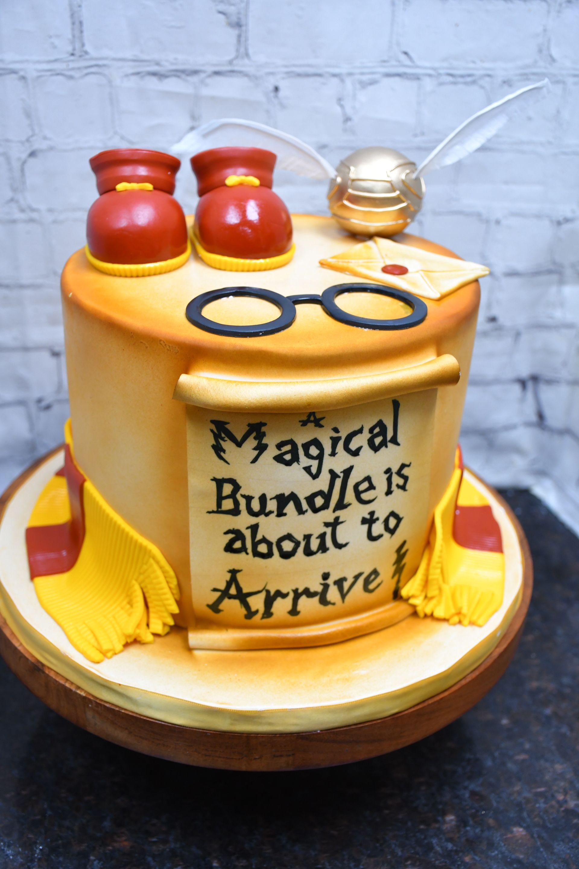 A harry potter cake that says the magical bundle is about to arrive