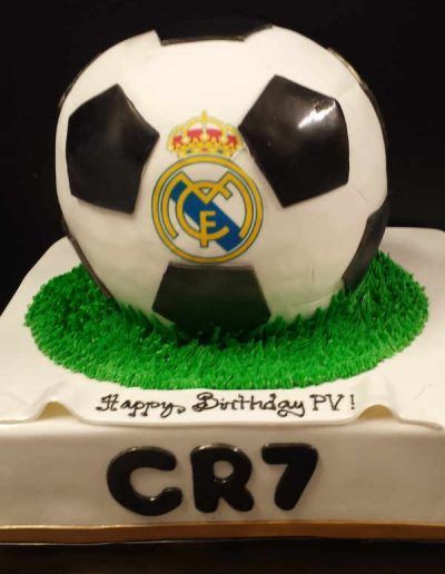 A birthday cake with a real madrid soccer ball on top