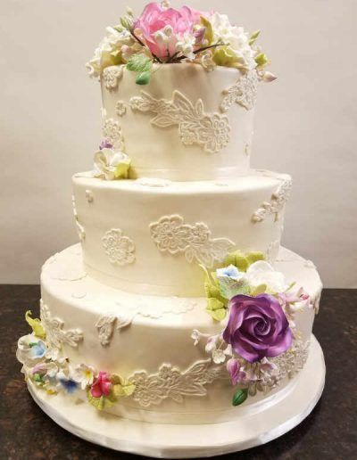 A white cake with flowers on top of it