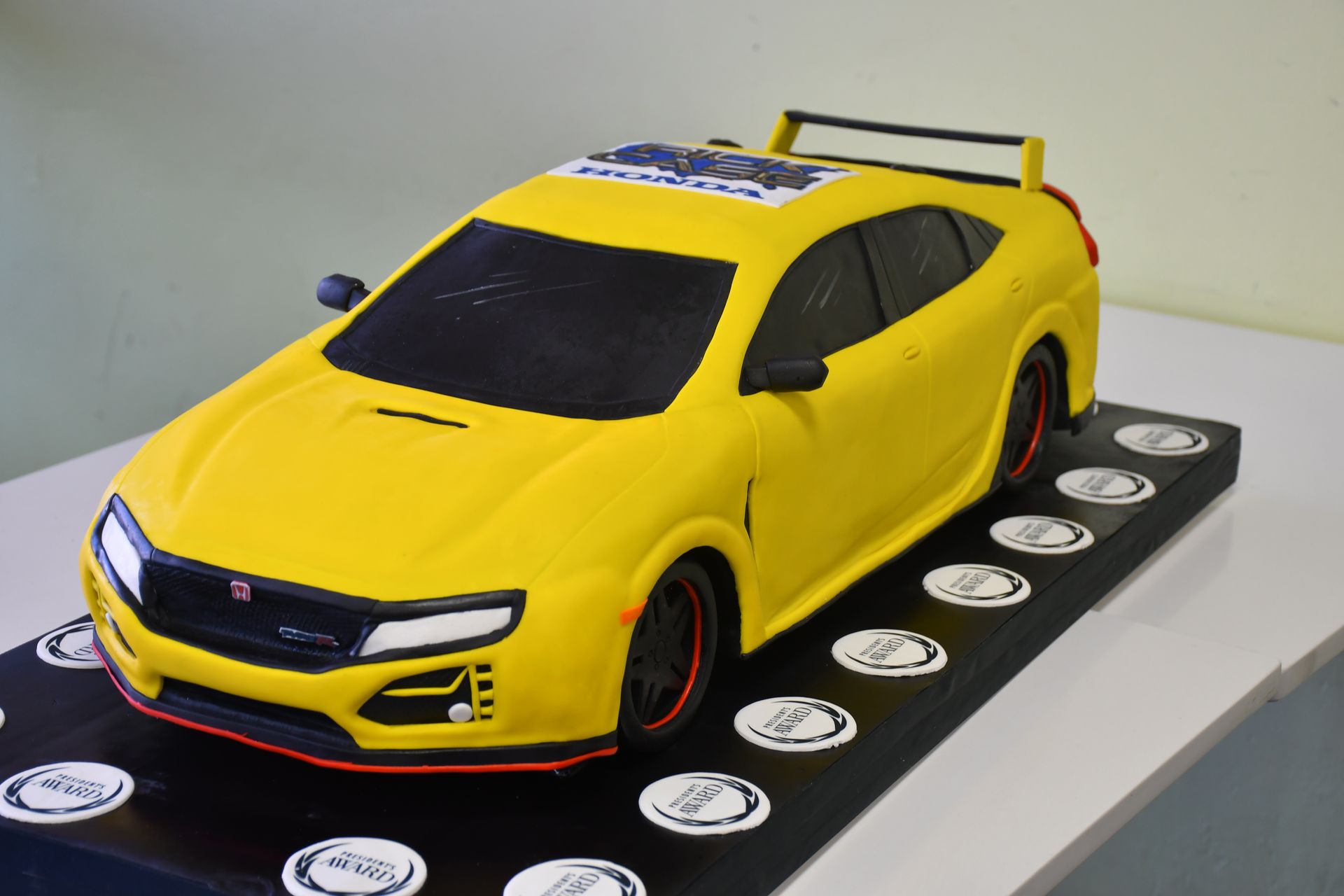 A model of a yellow car is sitting on a table