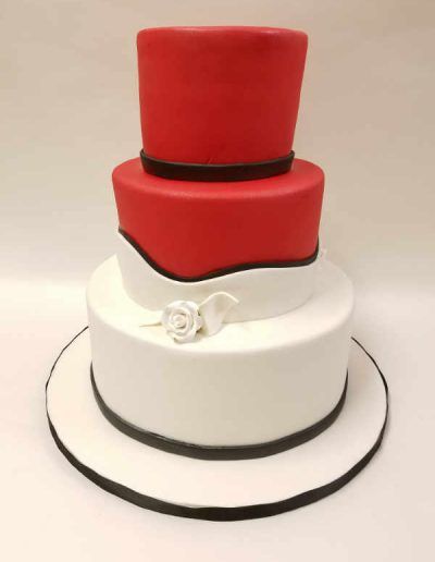 A red and white cake with a top hat on it