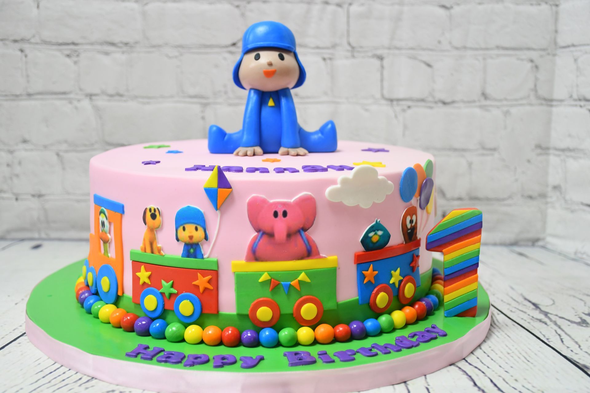 A birthday cake with pocoyo on top of it