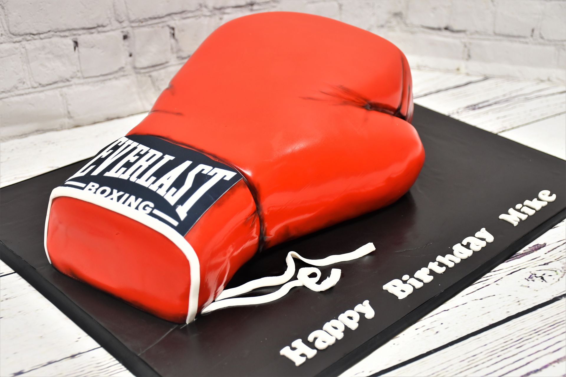 A cake in the shape of an everlast boxing glove