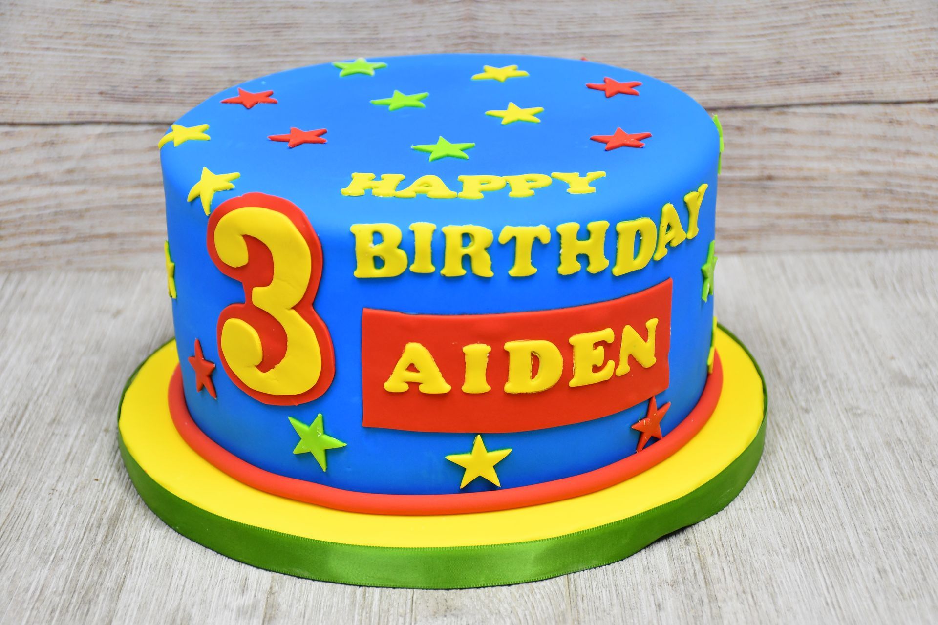 A birthday cake for a 3 year old boy named aiden