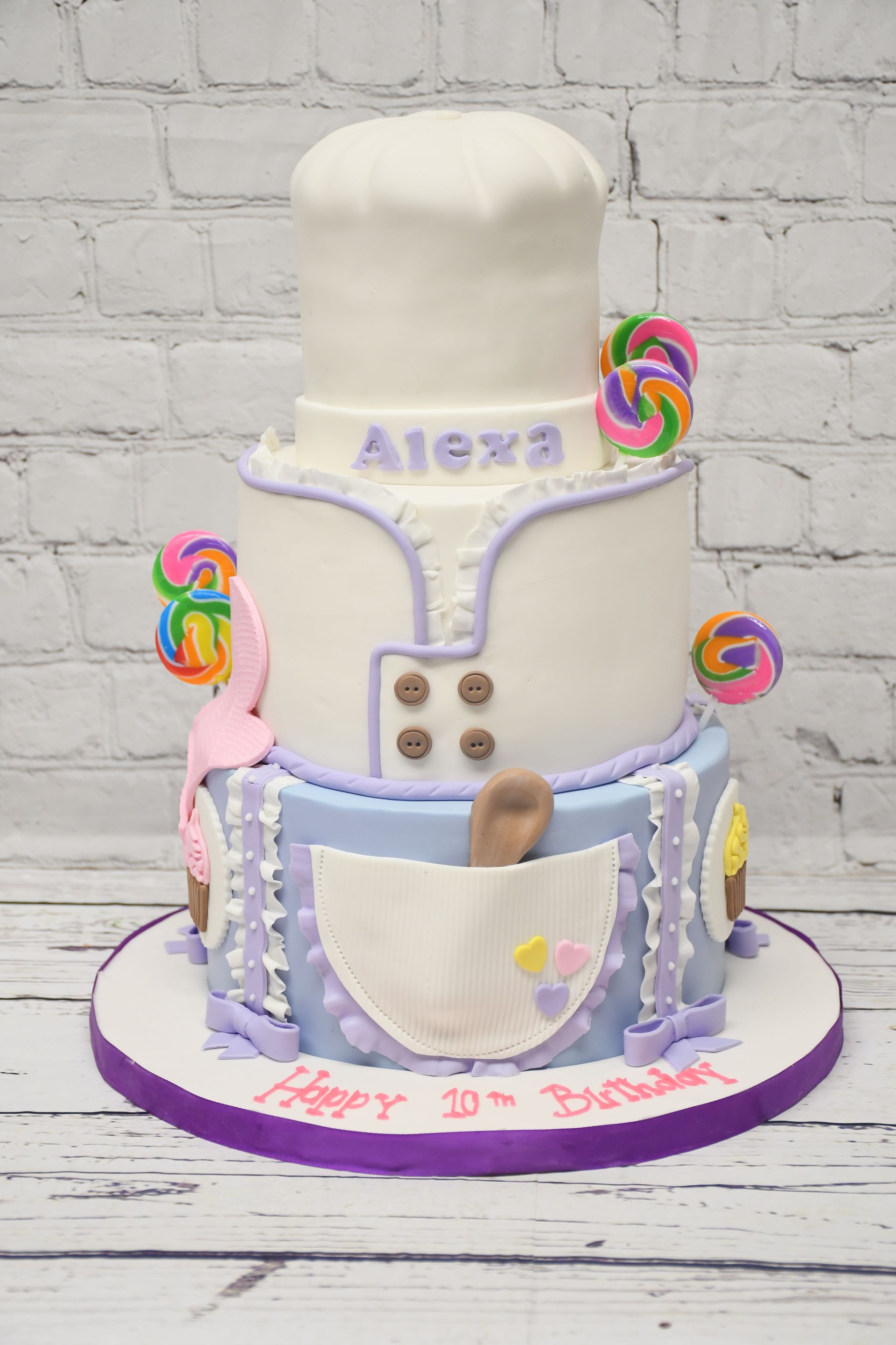 A cake with a chef 's hat and apron on it