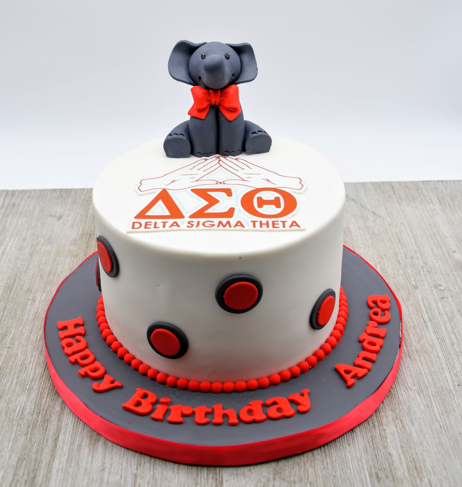 A delta sigma theta birthday cake with an elephant on top