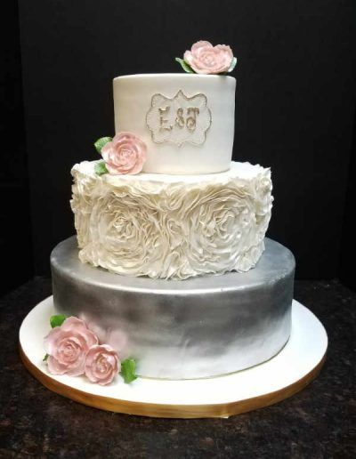 A wedding cake with the letters e & s on it