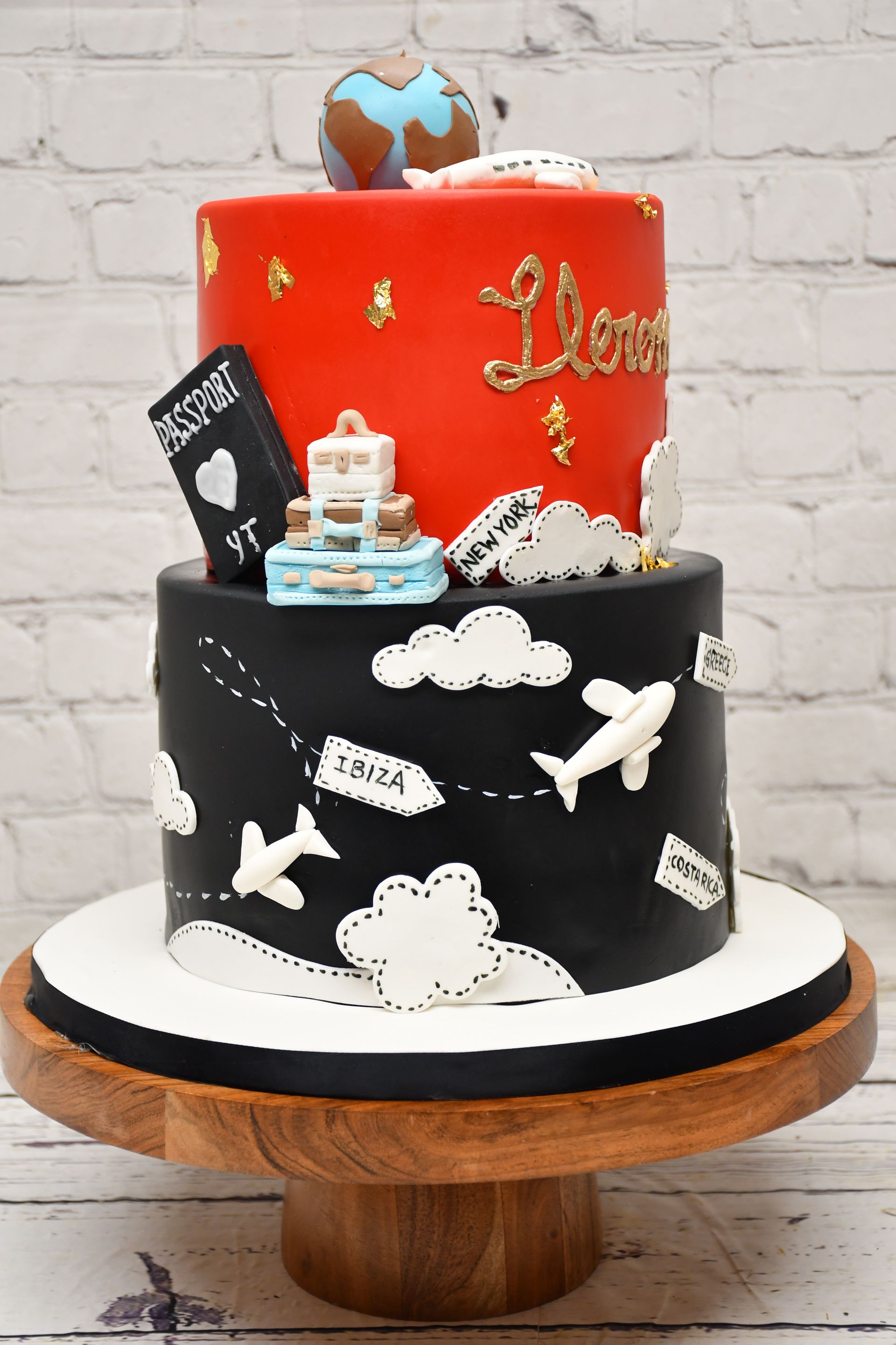 A red and black cake with a globe on top of it