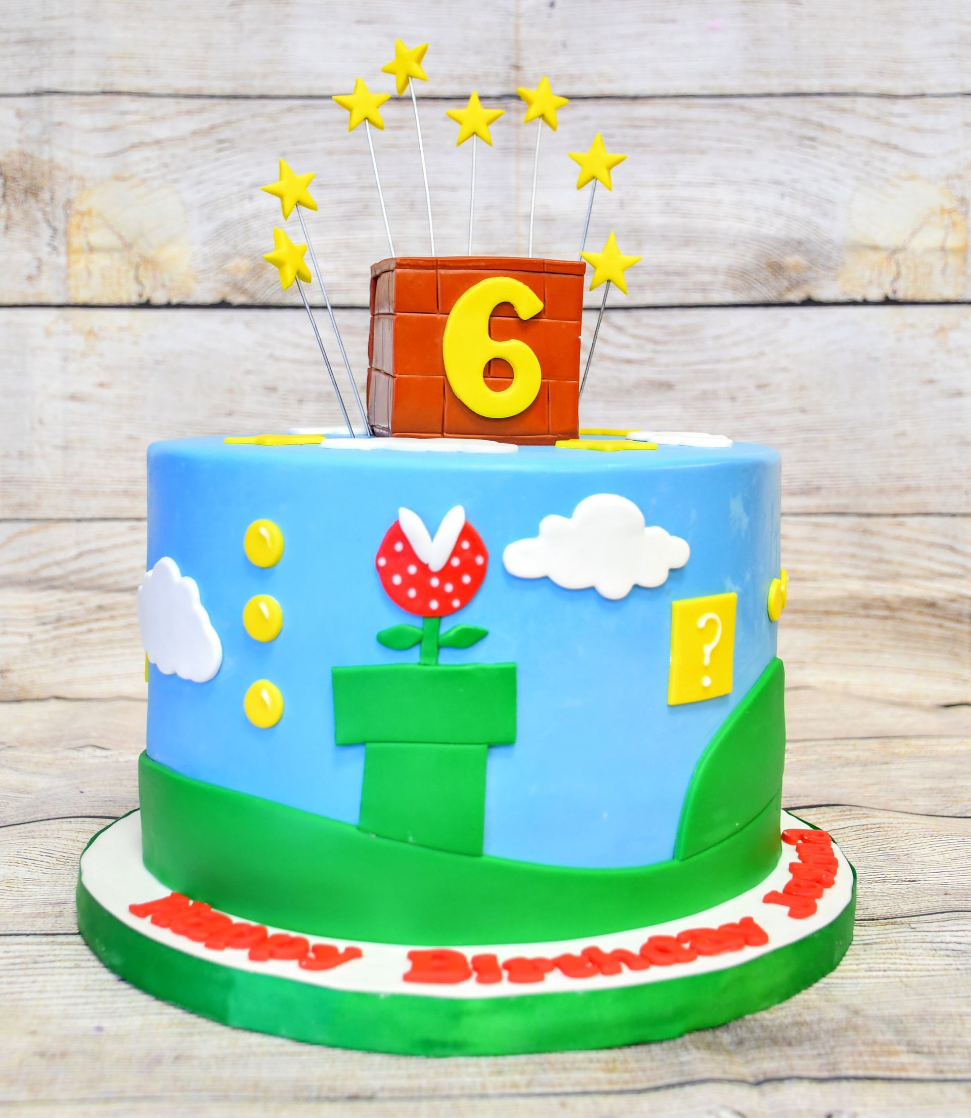 A birthday cake with the number 6 on top