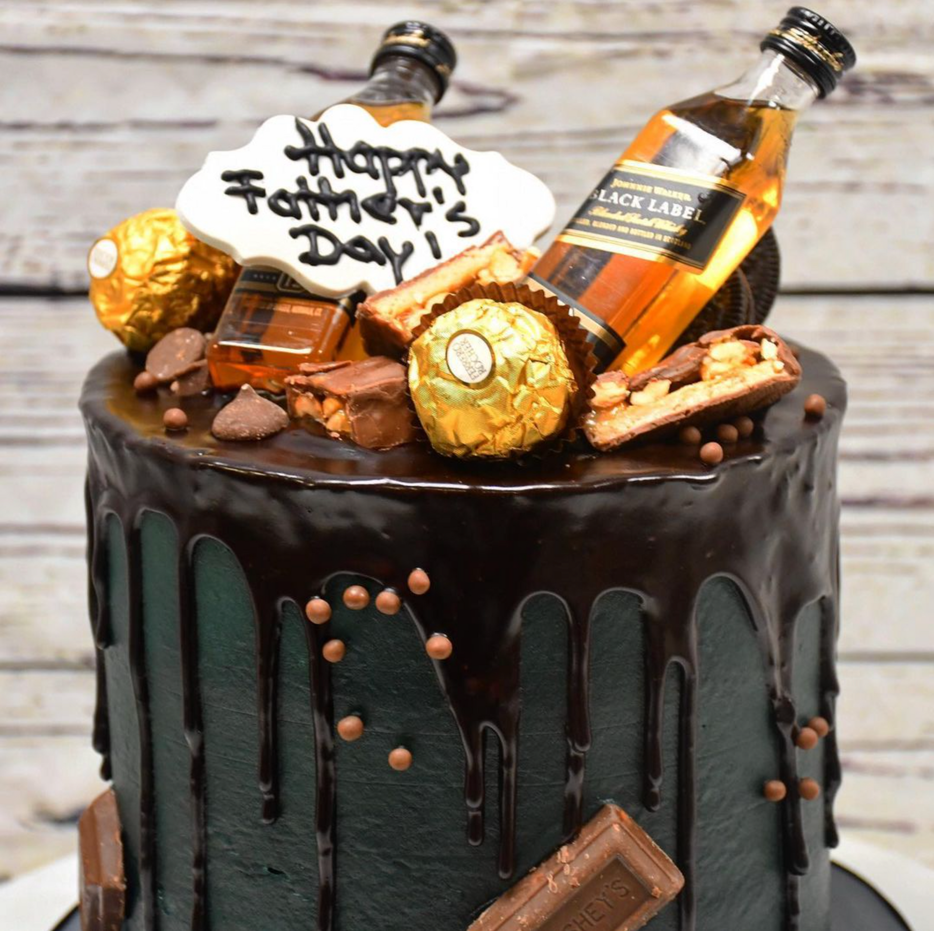A father 's day cake with a bottle of whiskey on top
