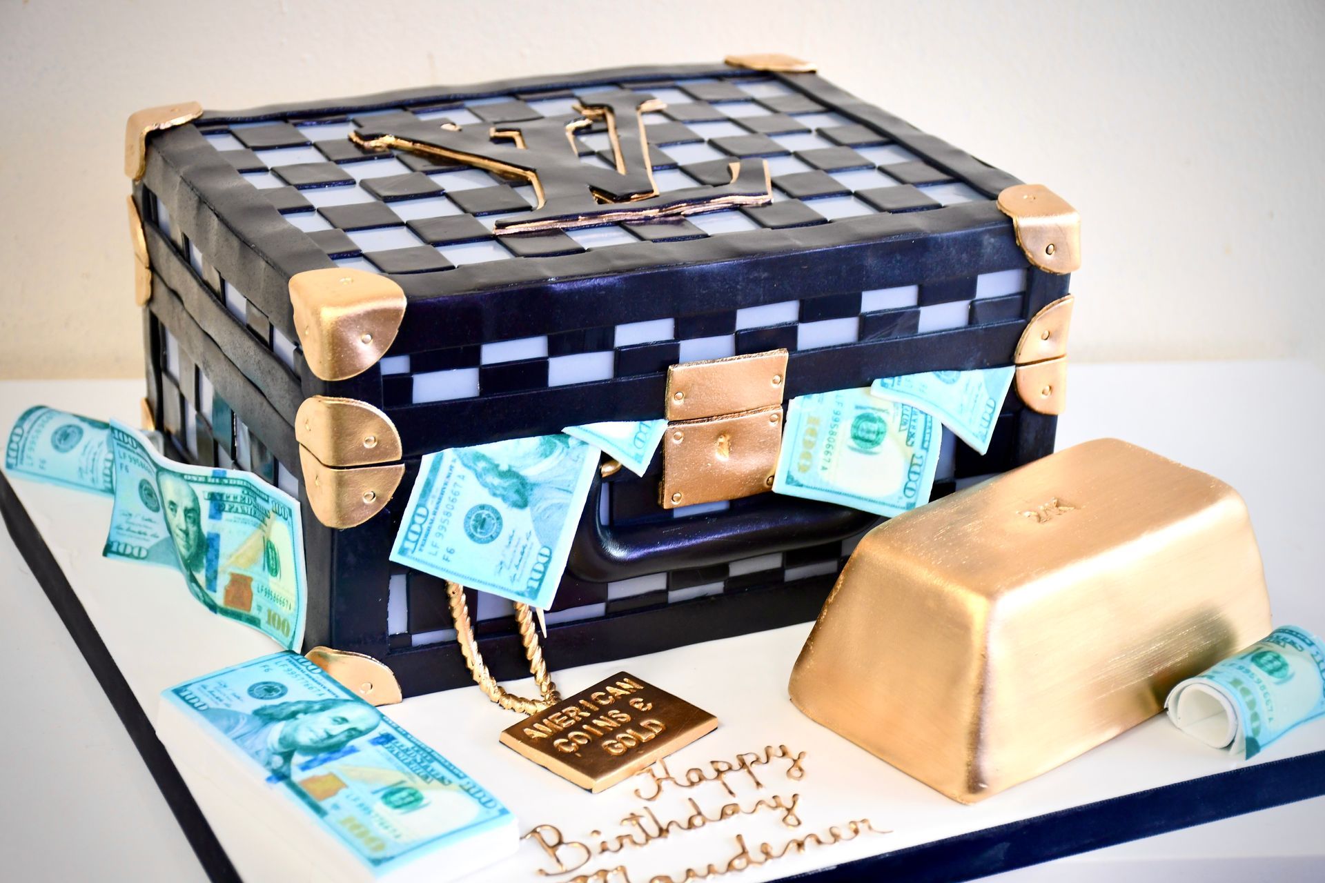 A birthday cake in the shape of a suitcase filled with money