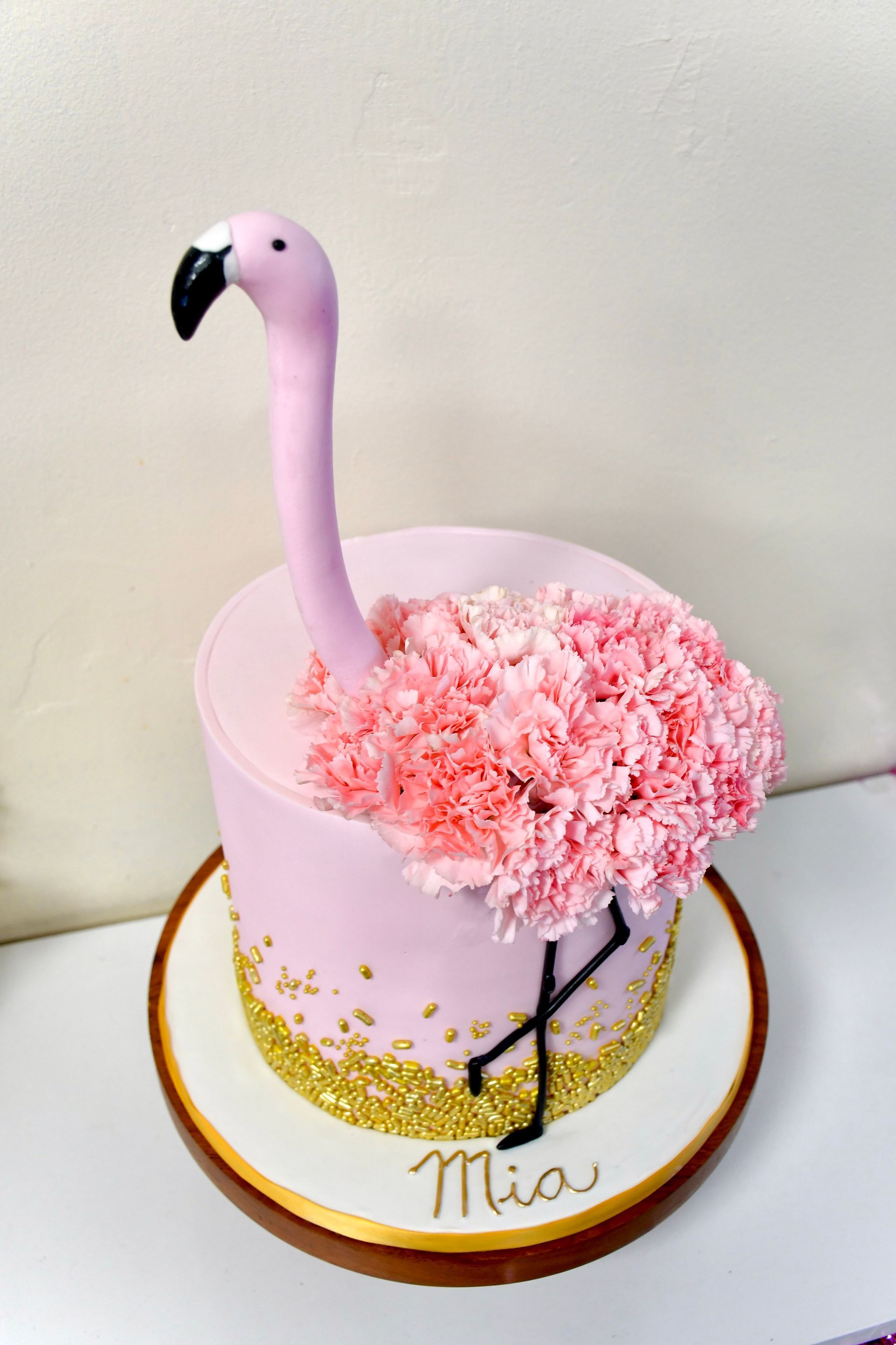 A cake with a flamingo on top of it