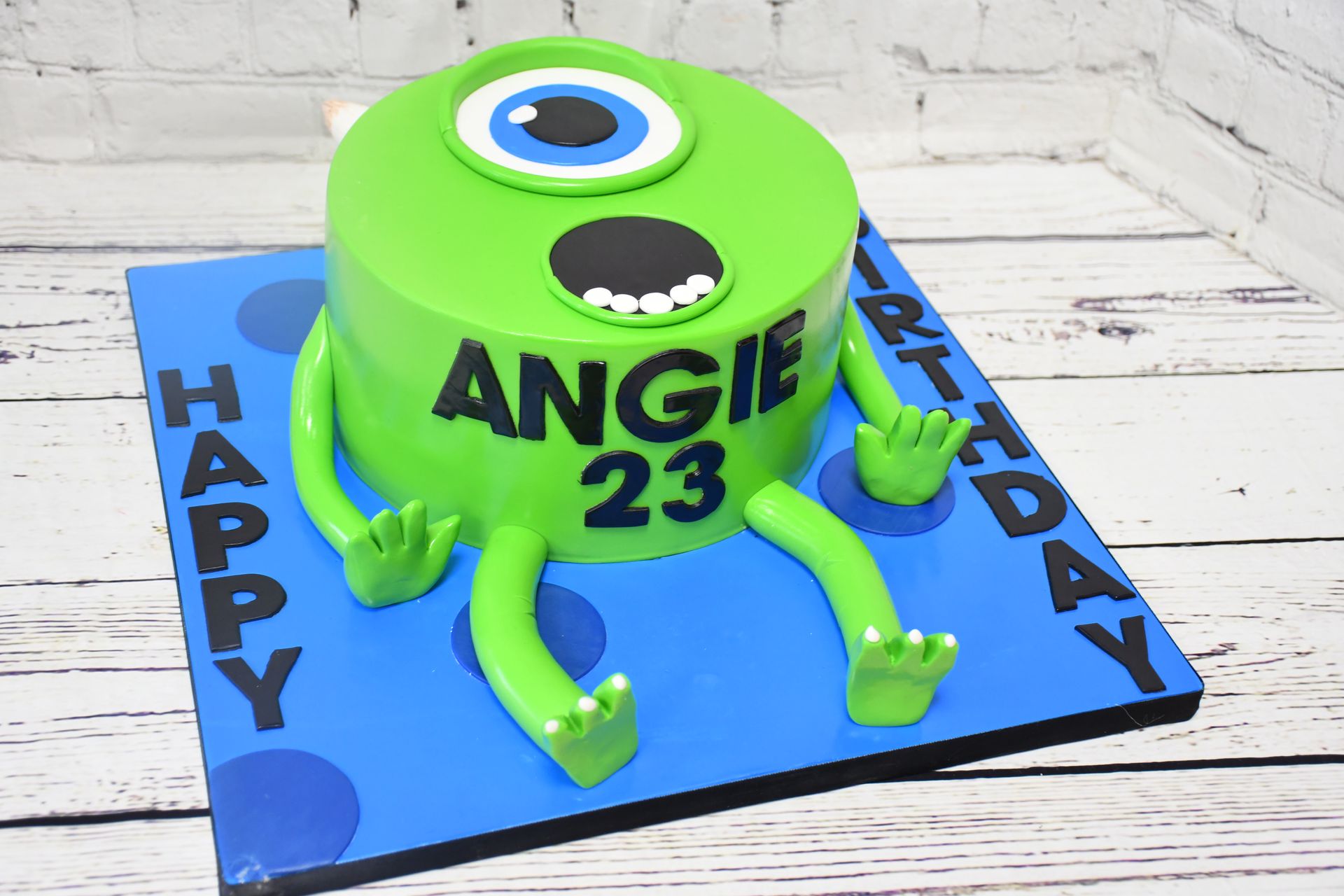 A green monster cake with the number 23 on it