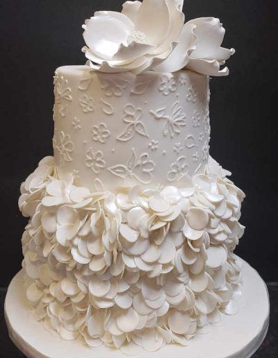 A white cake with a flower on top of it