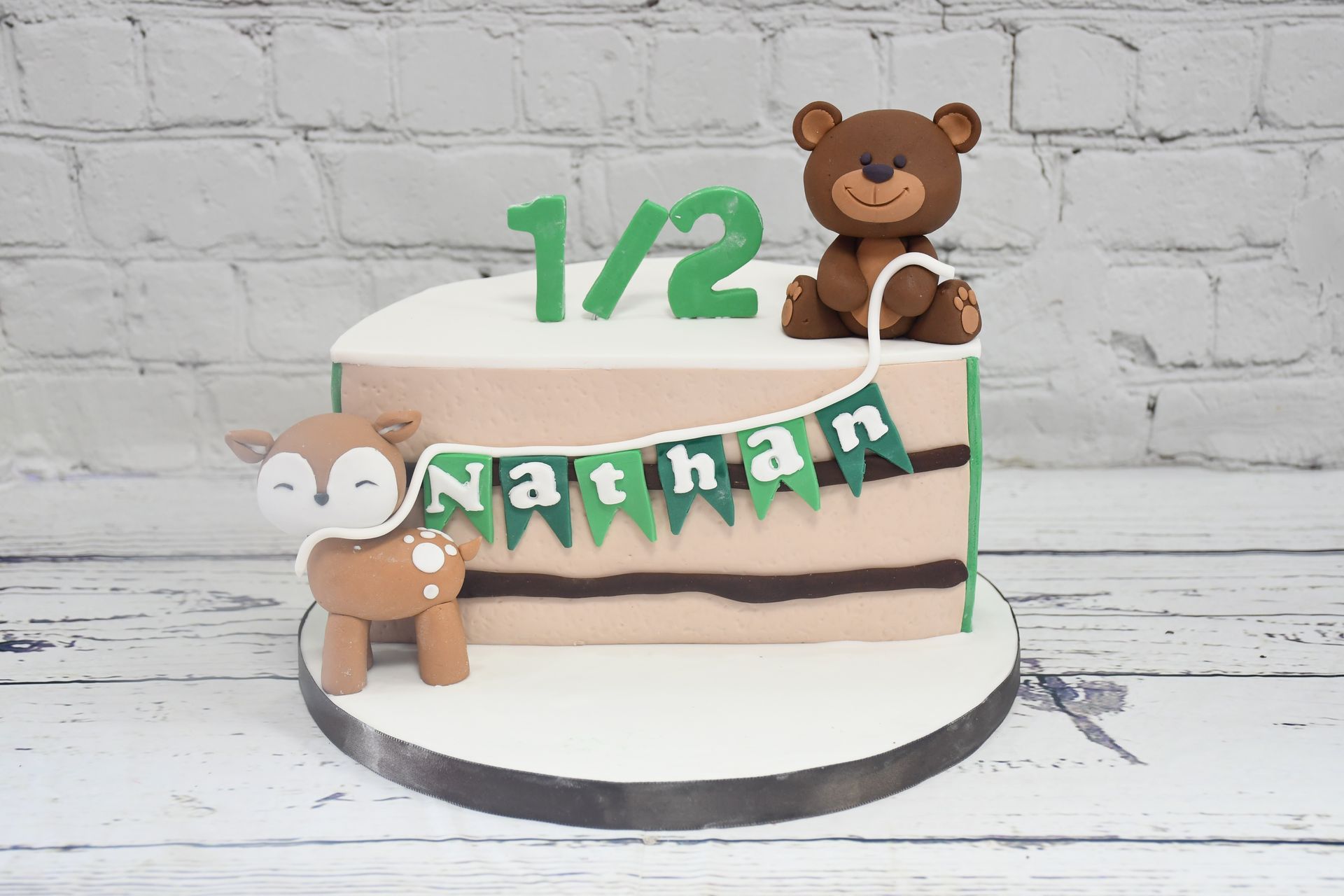 A half birthday cake for nathan with a teddy bear on top