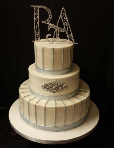 A wedding cake with the initials pa on top