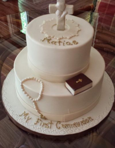 A white cake that says my first communion on it
