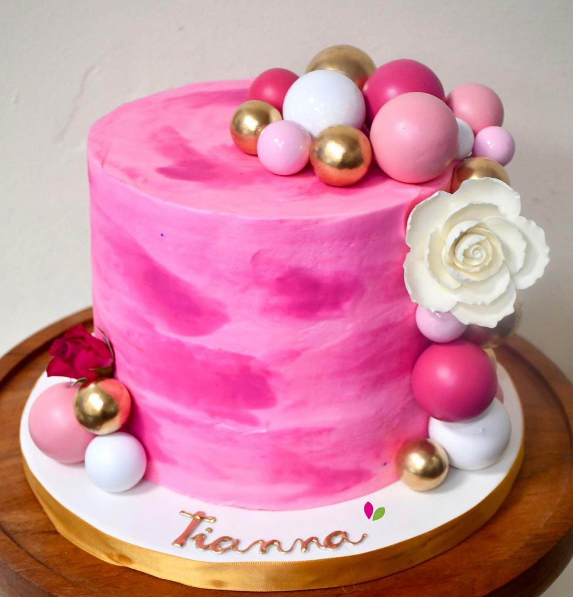 A pink cake with the name tianna on it