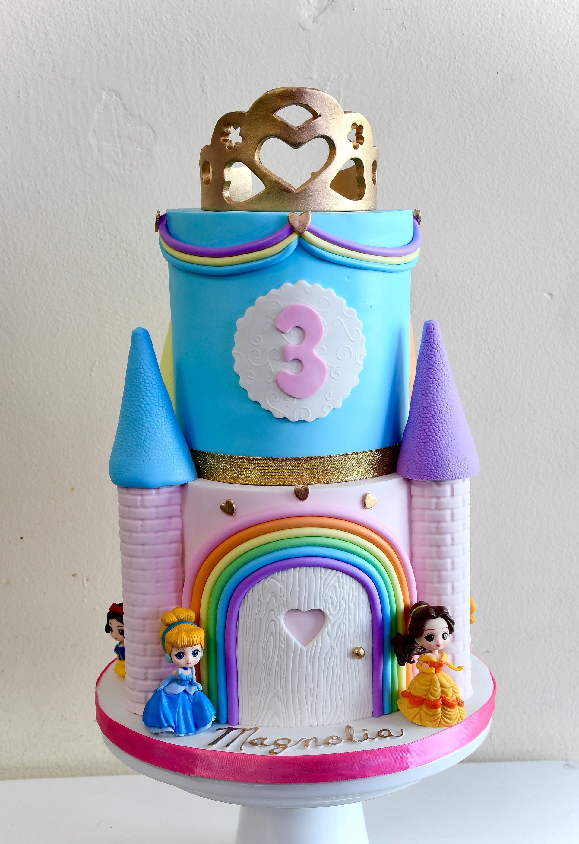 A cake that looks like a castle with the number 3 on it