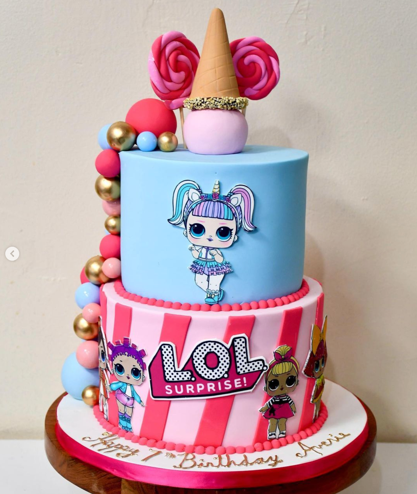 A lol surprise cake with lol dolls on it