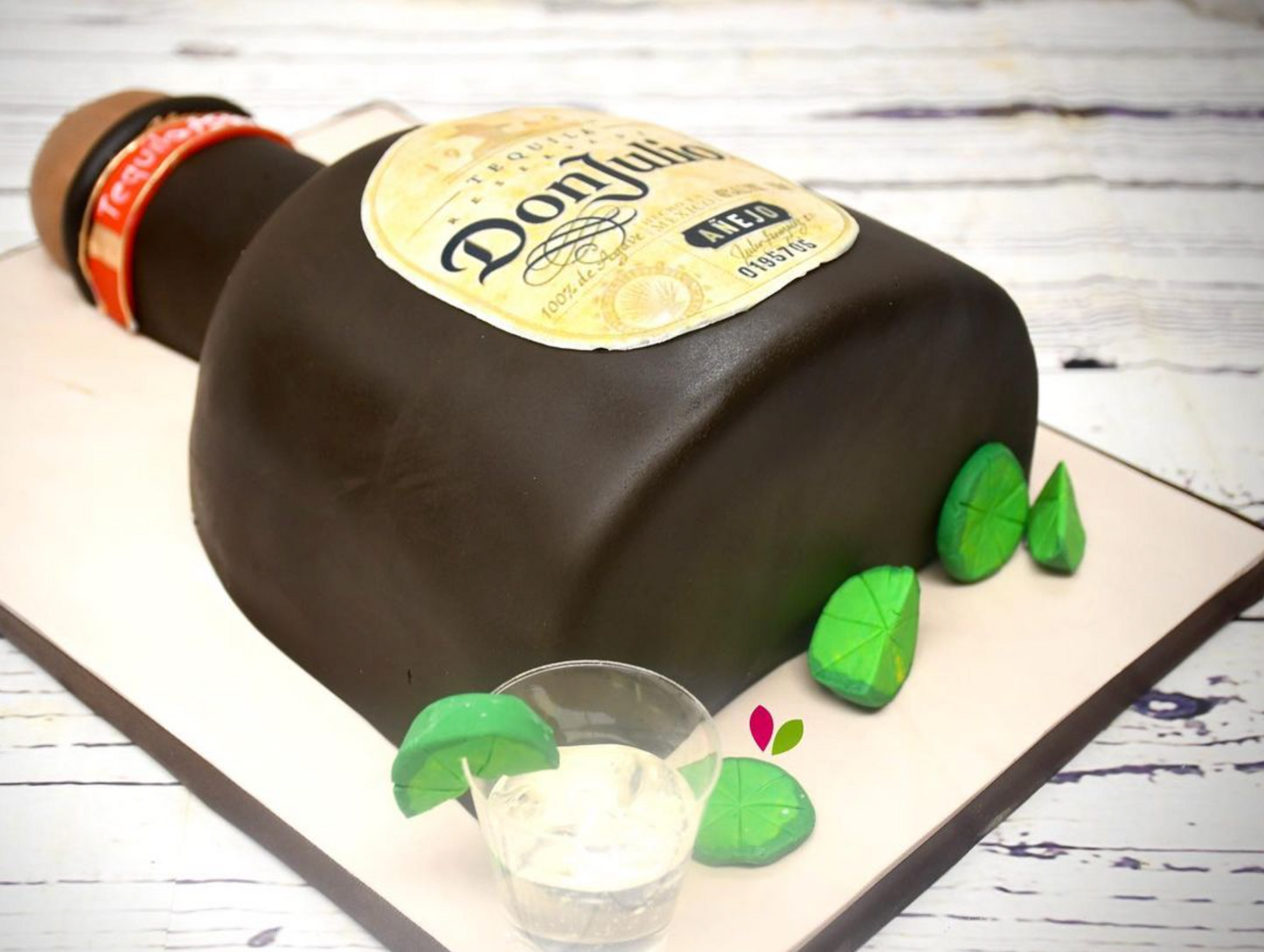 A cake in the shape of a bottle of don julio tequila
