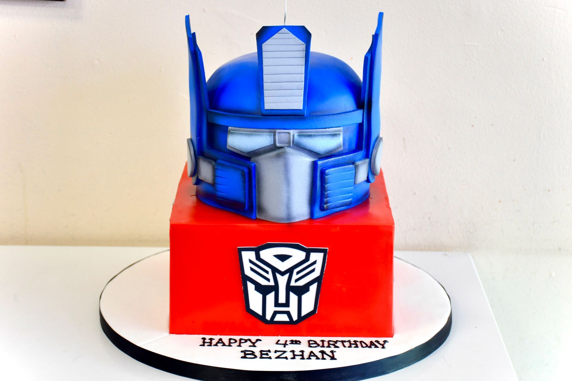 A birthday cake with a transformer on top of it