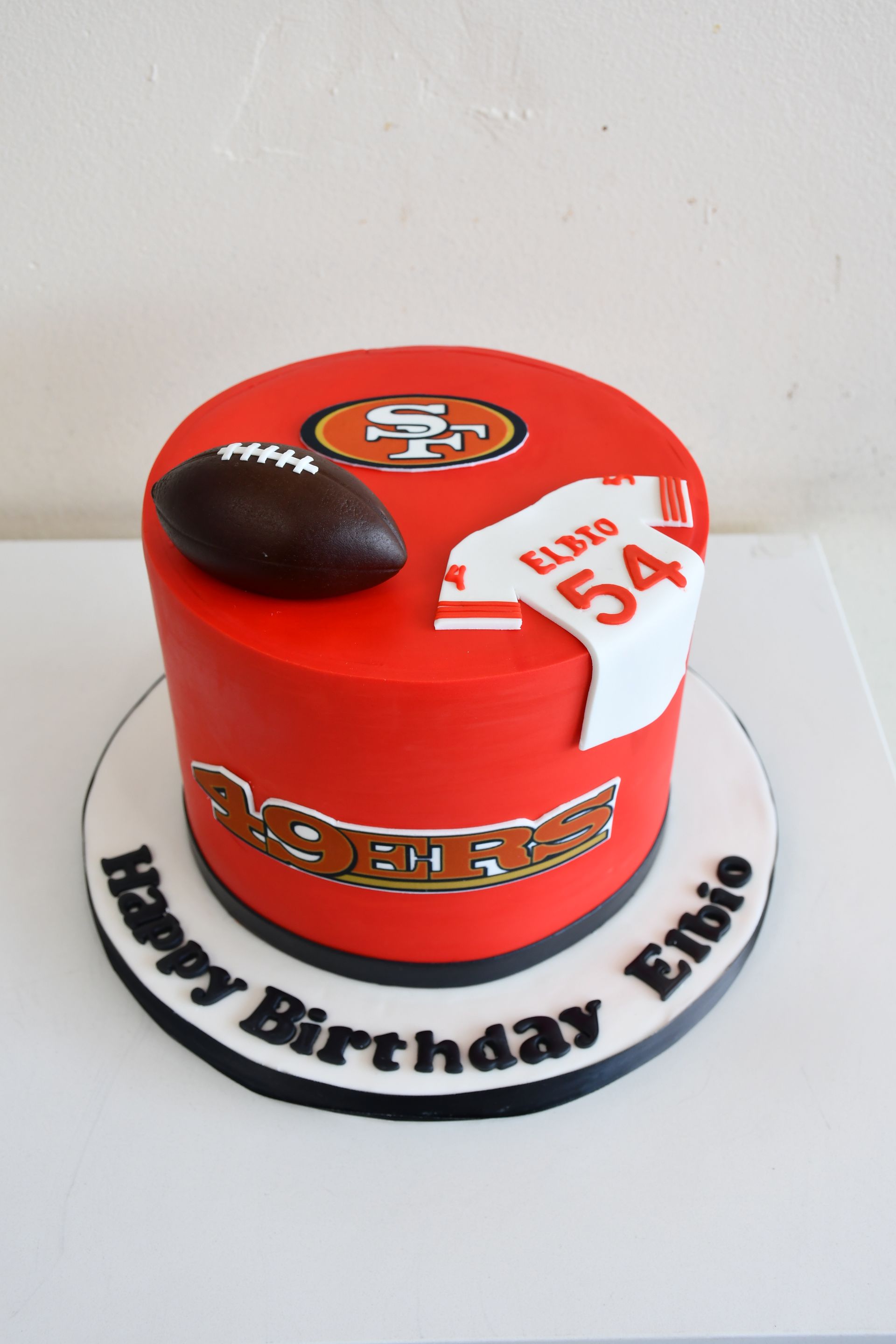 A red cake with the number 54 on it