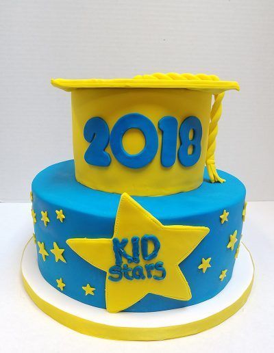 A blue and yellow cake that says kid stars on it
