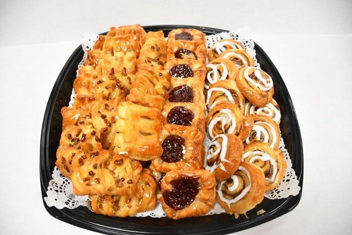 There are many different types of pastries on the tray.