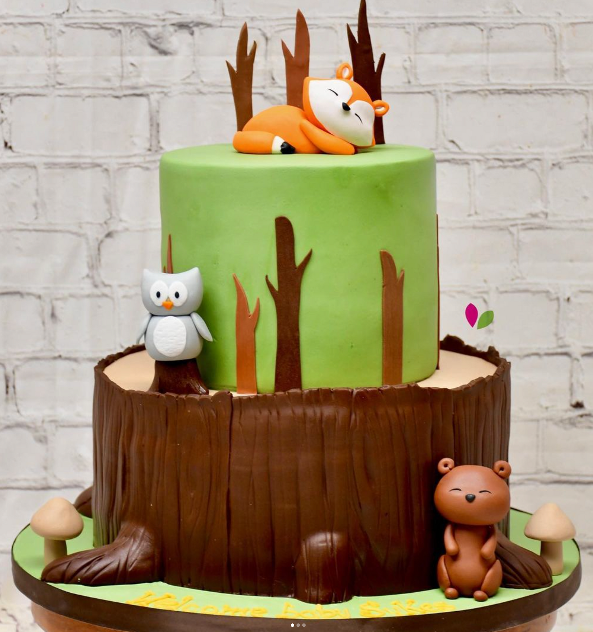 A cake with a fox sleeping on top of it