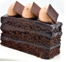 A slice of chocolate cake with chocolate squares on top