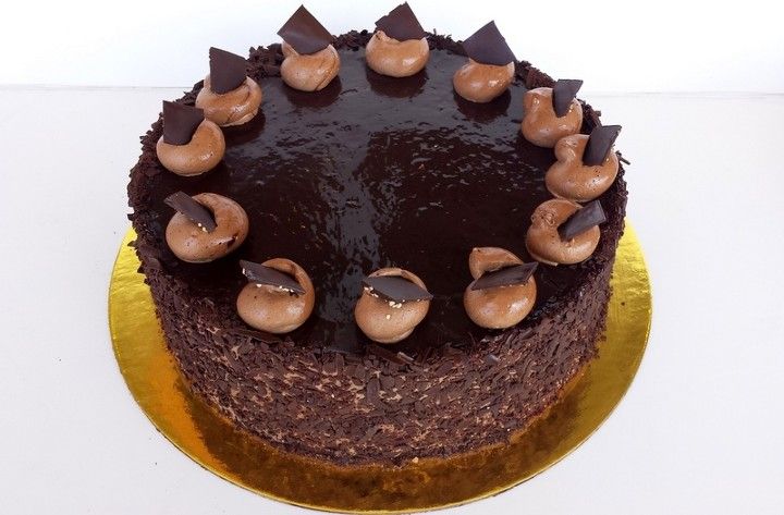 A chocolate cake with chocolate frosting on top of it