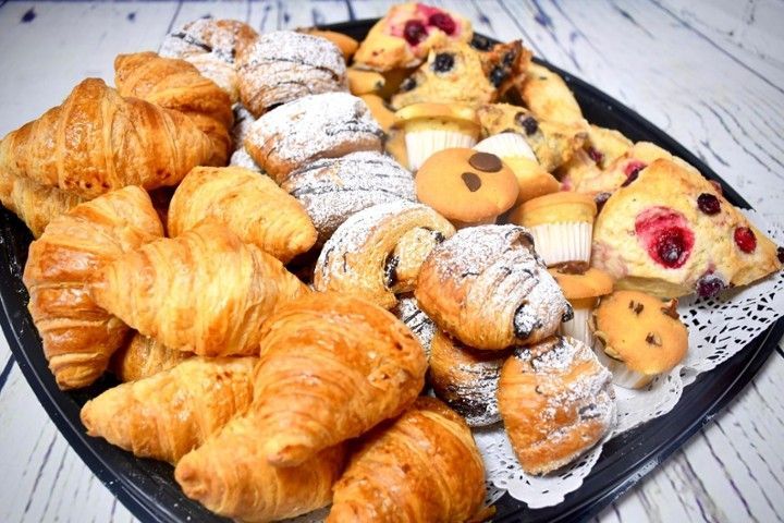 There are many different types of pastries on the tray.