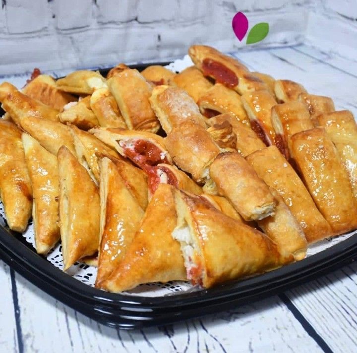 A black tray filled with pastries on a table