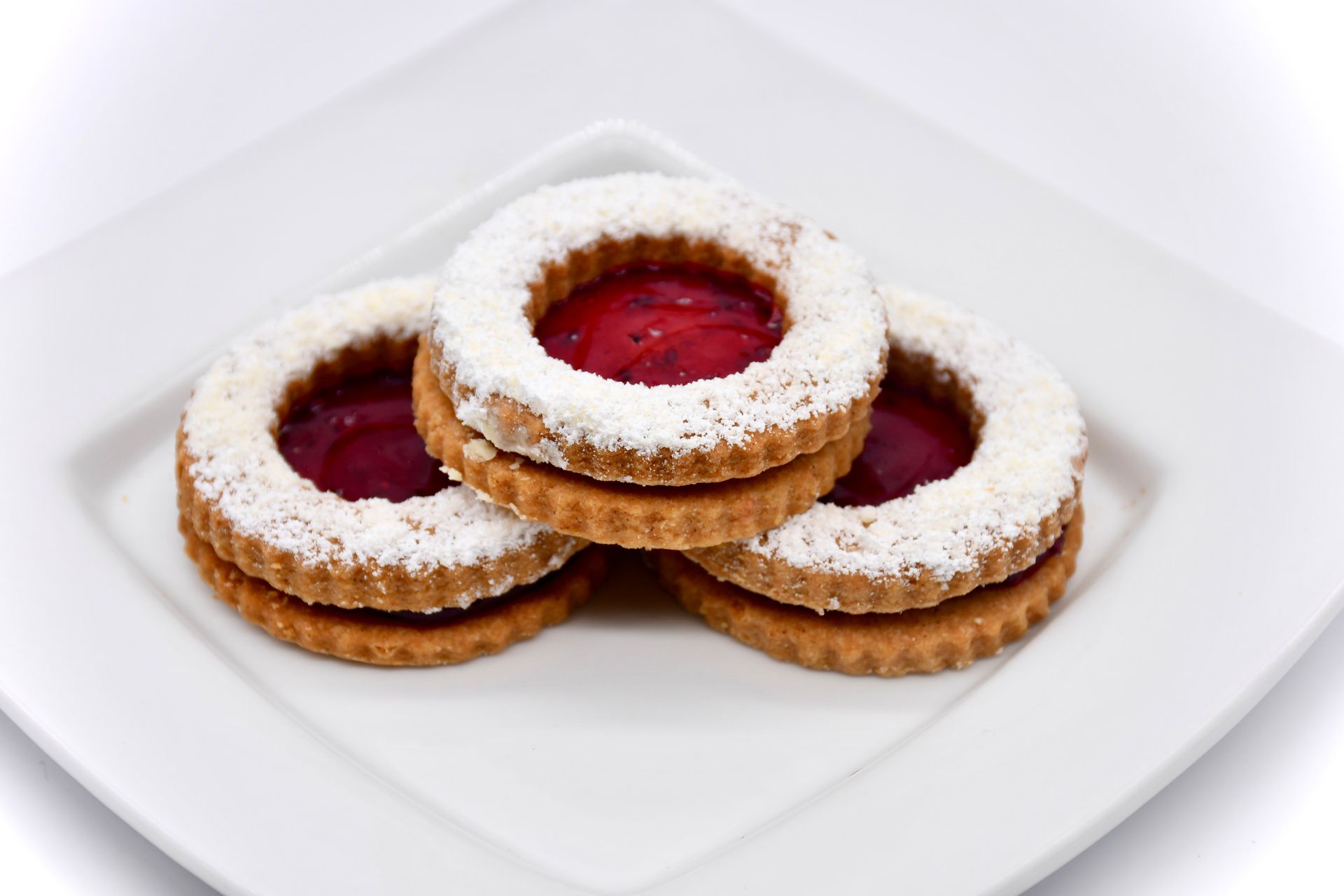 Three cookies stacked on top of each other on a white plate