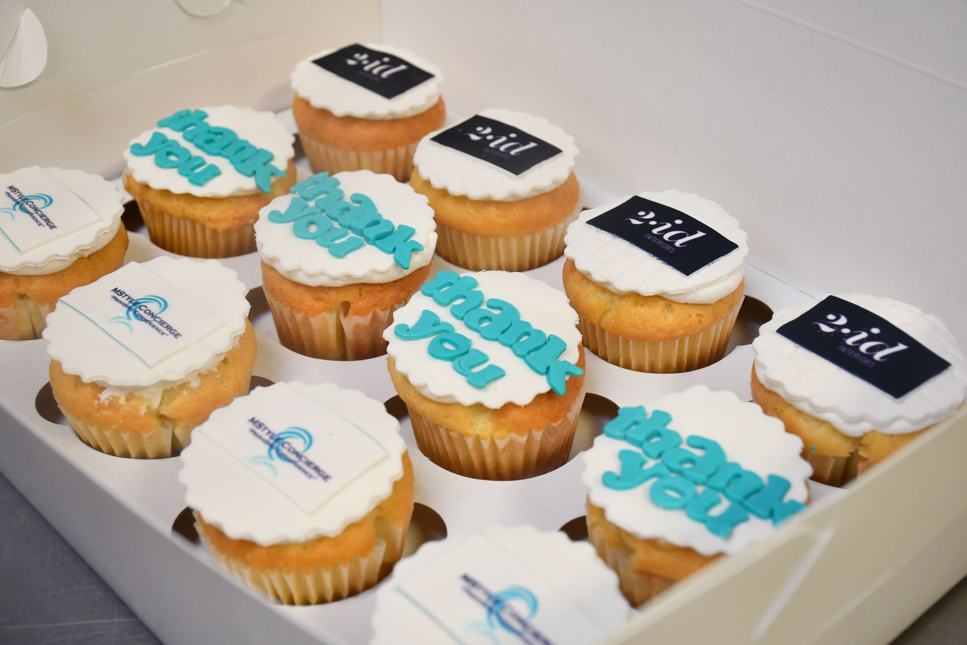 A box of cupcakes with thank you written on them
