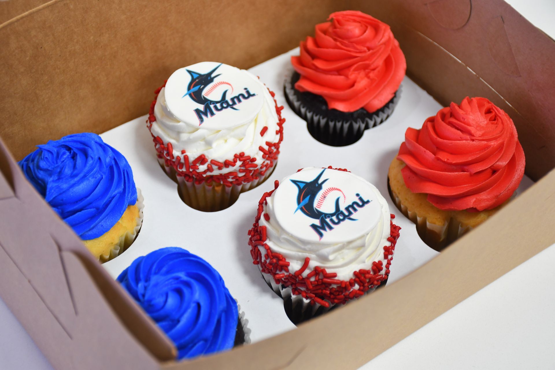 A box of cupcakes with miami written on them