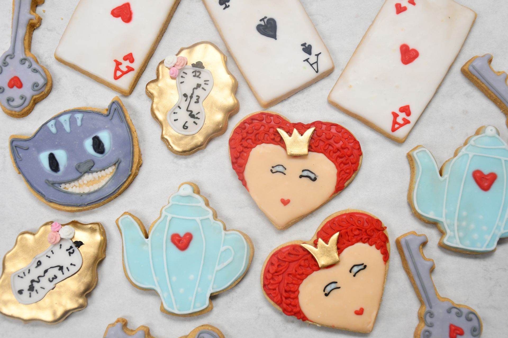 A bunch of alice in wonderland cookies on a table
