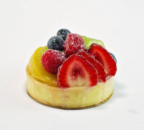 A fruit tart with strawberries and blueberries on top