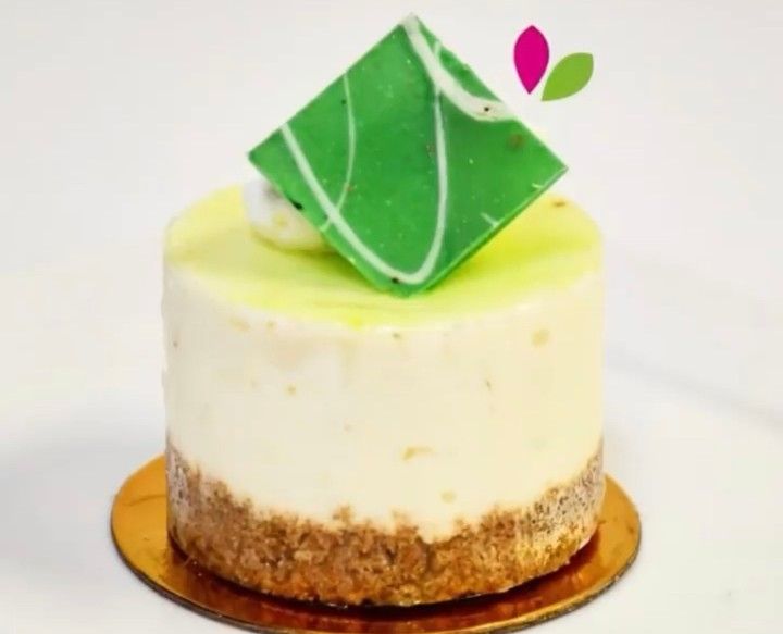A small cake with a green square on top