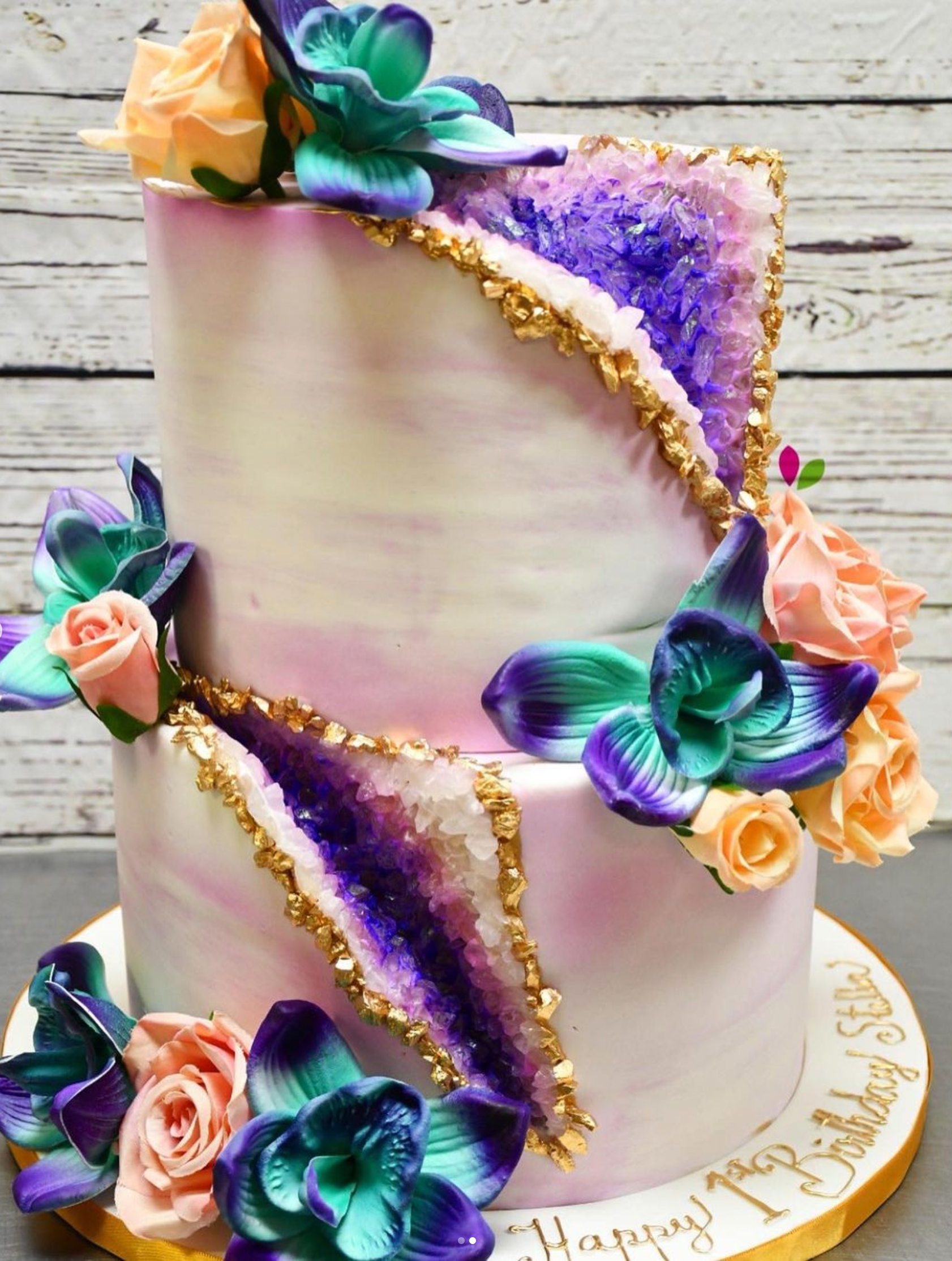 A purple and white cake with flowers on it
