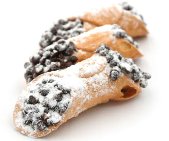 Three cannoli with chocolate chips and powdered sugar on a white background