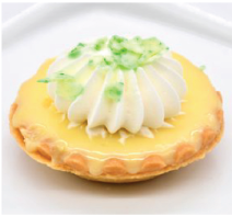 A lemon pie with whipped cream on top is on a white plate.