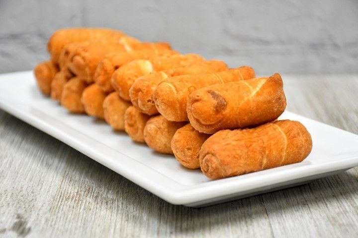 A white plate topped with fried food on a wooden table.