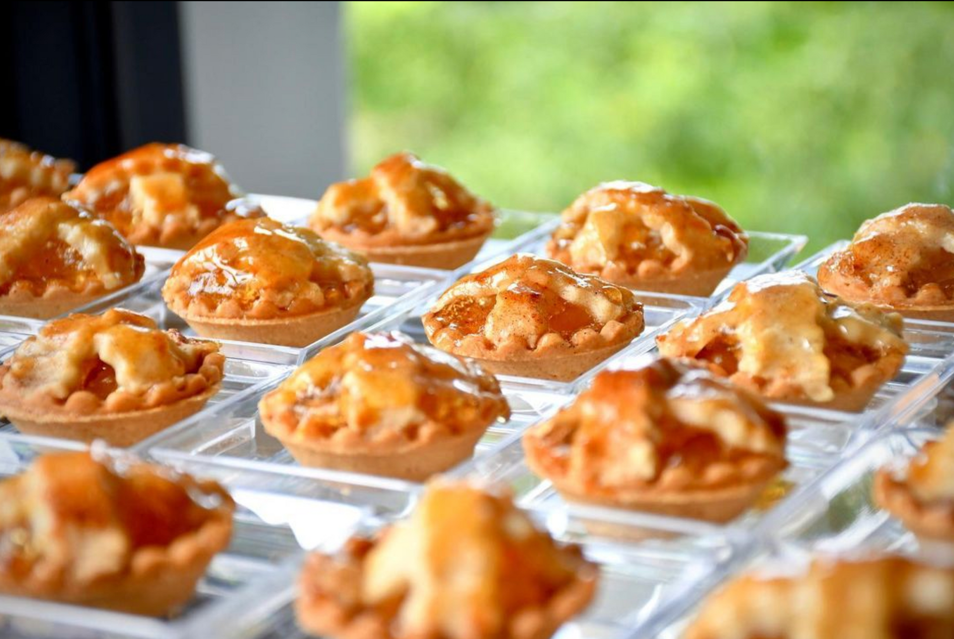 A bunch of apple pies are sitting on a table.